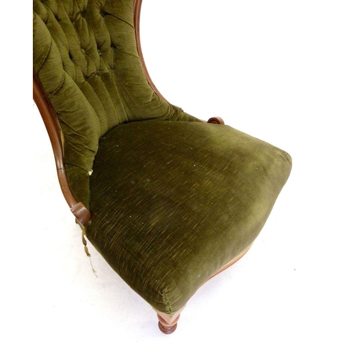 1133 - A Victorian green upholstered button back nursing chair with carved floral top rail