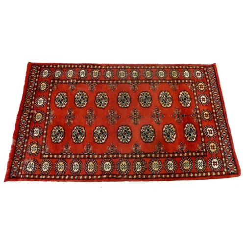 1138 - A red Turkoman rug with two rows of guls, 158 x 94 cm