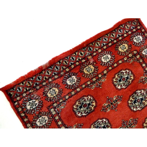 1138 - A red Turkoman rug with two rows of guls, 158 x 94 cm