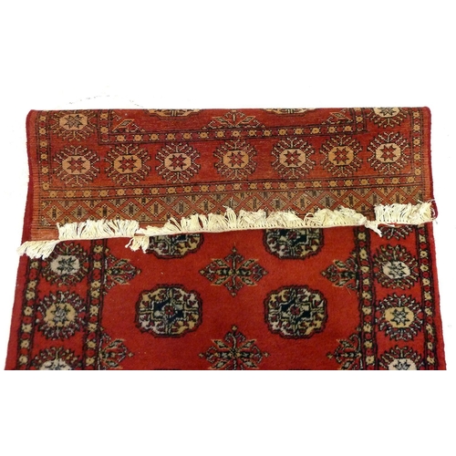 1138 - A red Turkoman rug with two rows of guls, 158 x 94 cm