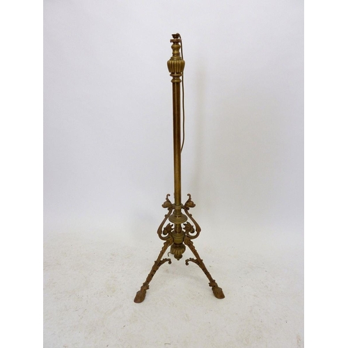 1145 - A 19th century brass extending standard lamp base with scrollwork and triple hoof feet