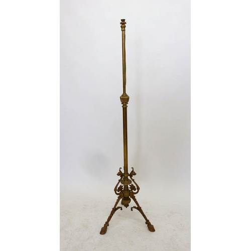 1145 - A 19th century brass extending standard lamp base with scrollwork and triple hoof feet