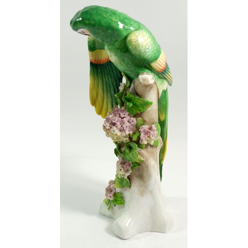 116 - A large continental porcelain parrot on floral tree stump, 27 cm