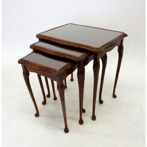 1192A - A nest of three mahogany occasional tables with glass tops