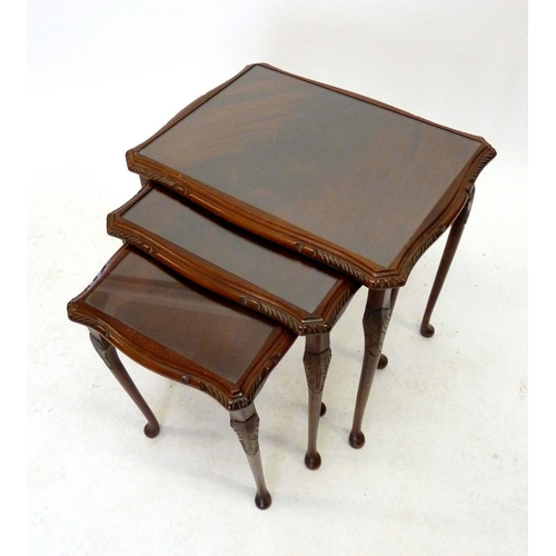 1192A - A nest of three mahogany occasional tables with glass tops