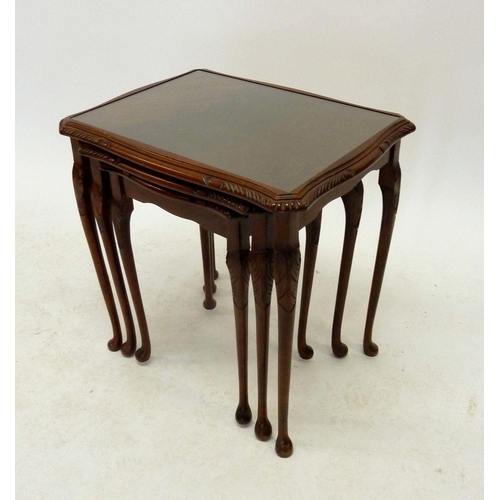 1192A - A nest of three mahogany occasional tables with glass tops