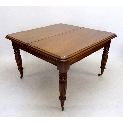 1193 - A large Victorian mahogany wind out dining table with two interleaves all on reeded supports, 110cm ... 