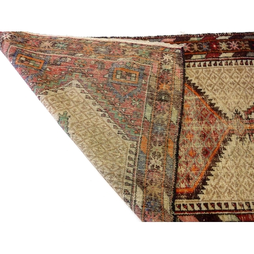 1196 - A tribal rug with cream ground and geometric motifs, a/f, 203 x 104 cm