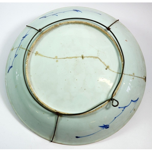 140 - A large Japanese blue and white charger 38cm diameter (repaired) and two oriental tea bowls