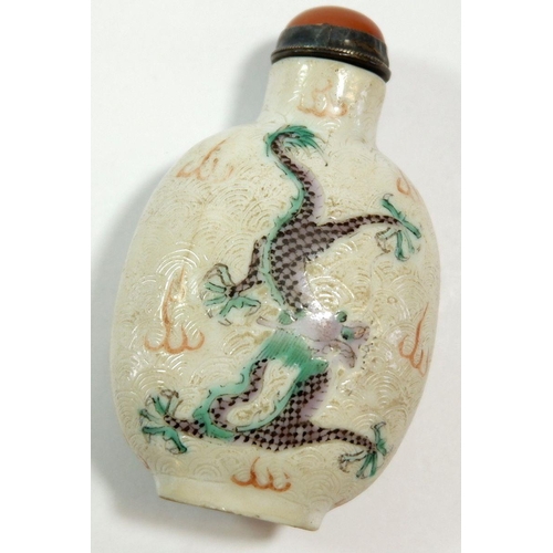 146 - A Chinese late Qing porcelain snuff bottle painted dragons amongst the waves with agate set lid and ... 