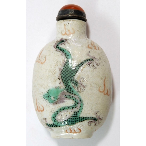 146 - A Chinese late Qing porcelain snuff bottle painted dragons amongst the waves with agate set lid and ... 