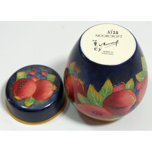 155 - A Moorcroft enamel miniature ginger jar and cover painted pomegranates on a blue ground, 7cm