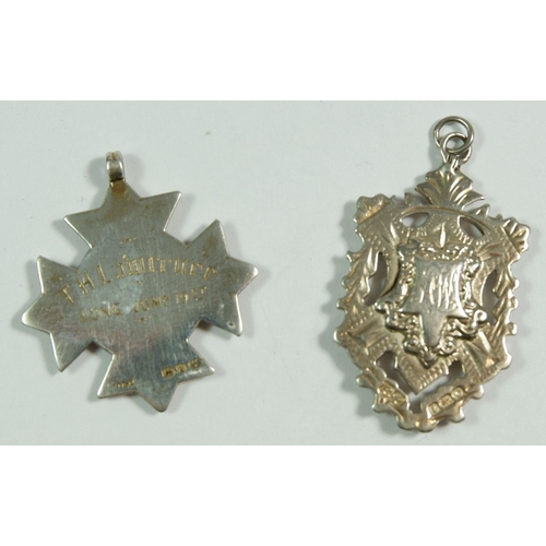 262 - A silver and 9ct gold sports fob 1895 by Vaughnon & Sons and a silver  one, 1913 by Robert Pringle &... 