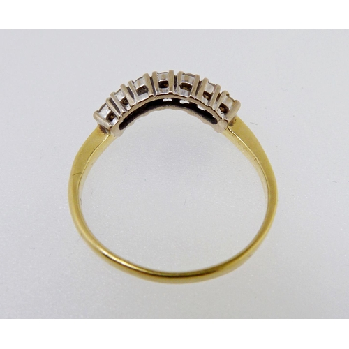 347 - An 18 carat gold ring set curve of seven diamonds, size M