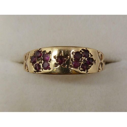 361 - A Victorian gold ring set garnets in a floral design (unmarked), Size S-T