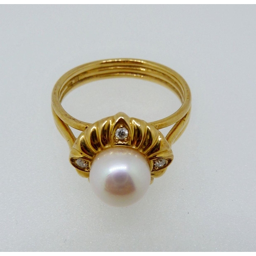 362 - An 18 carat gold ring set pearl with gadrooned surround set four diamonds, size L, 4.3g