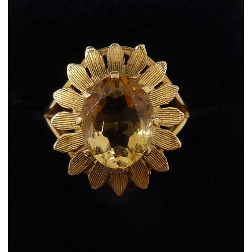 371 - A 9 carat gold ring set oval cut citrine within gold petal form surround, size M, 4.1g