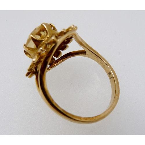 371 - A 9 carat gold ring set oval cut citrine within gold petal form surround, size M, 4.1g