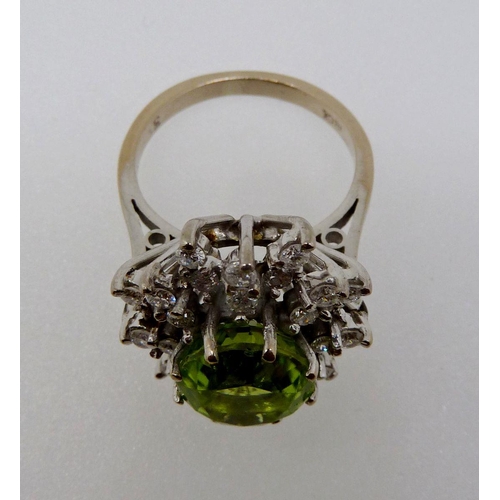 372 - An 18 carat gold peridot and diamond flower form cluster ring, size K, 7.5g