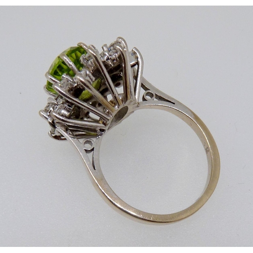 372 - An 18 carat gold peridot and diamond flower form cluster ring, size K, 7.5g