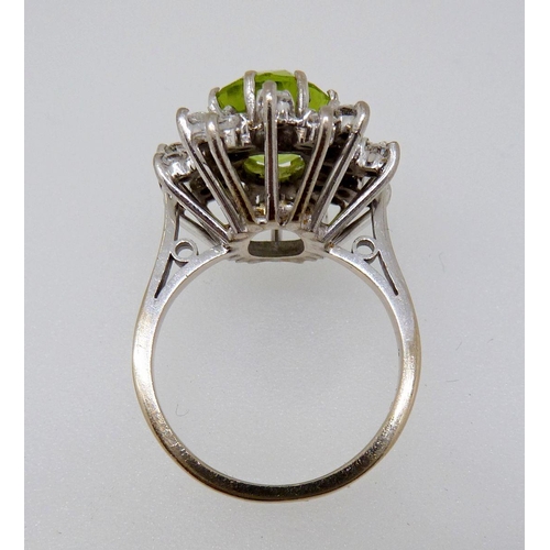 372 - An 18 carat gold peridot and diamond flower form cluster ring, size K, 7.5g