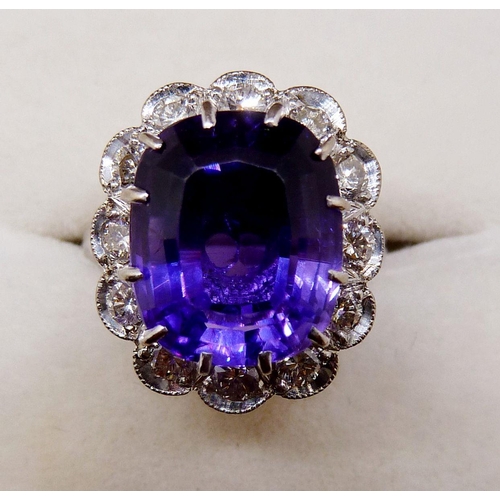 373 - An 18 carat gold ring set cushion cut amethyst within diamond surround, size K-L, 6.4g