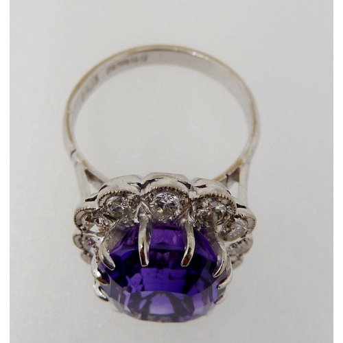 373 - An 18 carat gold ring set cushion cut amethyst within diamond surround, size K-L, 6.4g