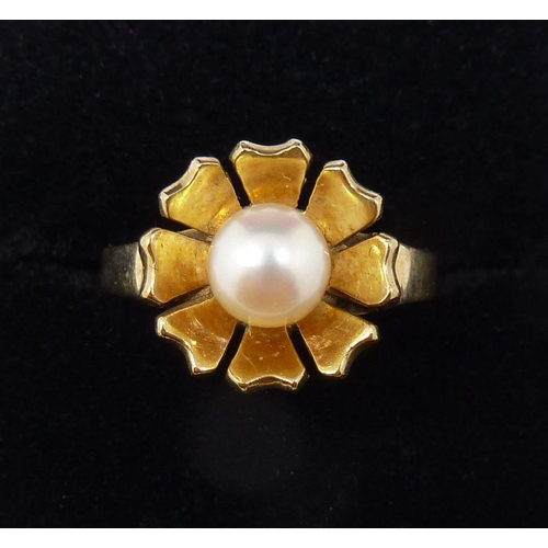 377 - A 9 carat gold ring set pearl in flower form surround, size L to M, 3.1g