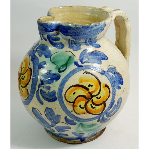 39 - An antique Majolica jug with blue and yellow decoration, 23cm tall