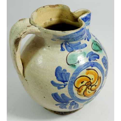 39 - An antique Majolica jug with blue and yellow decoration, 23cm tall