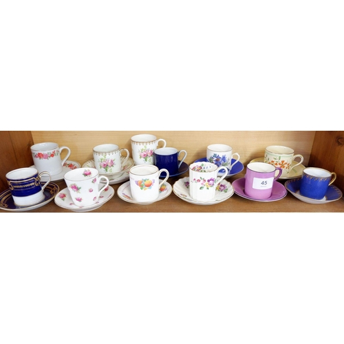 45 - A collection of nine decorative coffee cans and saucers