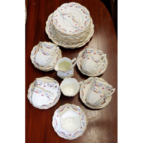 62 - An Edwardian blue and pink floral tea set comprising: ten tea cups, twelve saucers, twelve side plat... 