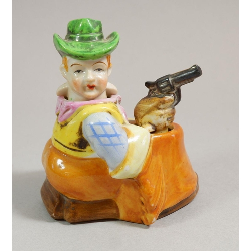 72 - A novelty continental porcelain nodding head cowboy and a Victorian cherub wall pocket