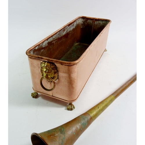 787 - A rectangular copper planter with lion masks and feet, 35cm and a copper and brass coaching horn