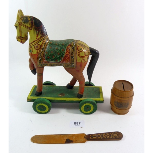 887 - A painted Indian toy wooden horse, a mauchline ware barrel money box and a Tunbridgeware paper knife