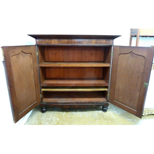 943 - A Victorian mahogany two door linen cabinet with carved foliage decoration and arch panelled door, 1... 