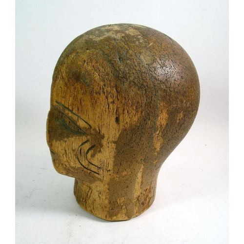 975 - A 1920's Art Deco carved wood milliners block with incised features, 17cm tall