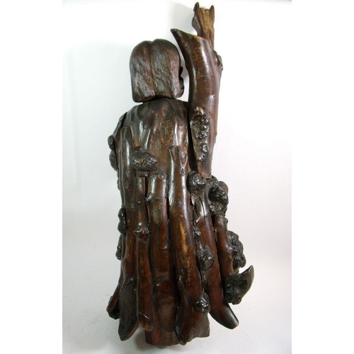 986 - A large Chinese root carving of a man with one arm raised, 61cm