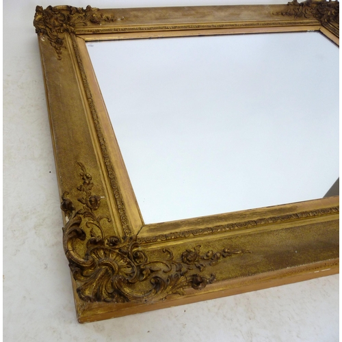 1140 - A 19th century carved and gilt mirror with shell and foliate corners, 87 x 98 cm