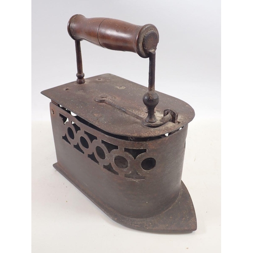 1014 - A Victorian large iron with pierced decoration and a large copper kettle