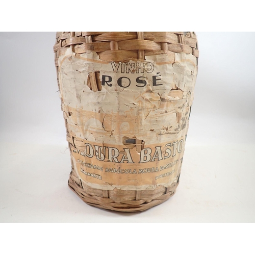 1021 - A wicker clad large Portuguese wine bottle, 38cm