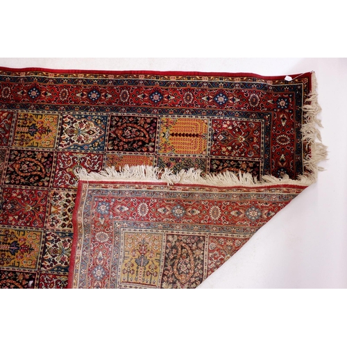 1031 - A Persian style wool carpet with floral and foliage decoration 279 x 185cm