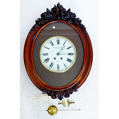 1197 - A French oval mahogany wall clock by 'Martin, Baskett and Martin' in floral carved and glazed case, ... 