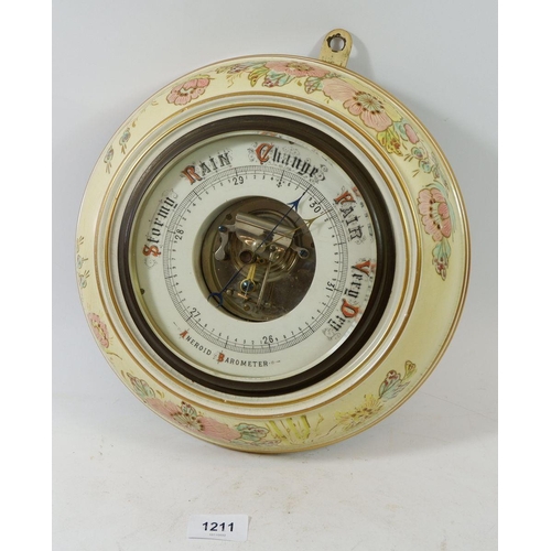 1211 - An Edwardian floral pottery framed aneroid barometer 28cm diameter