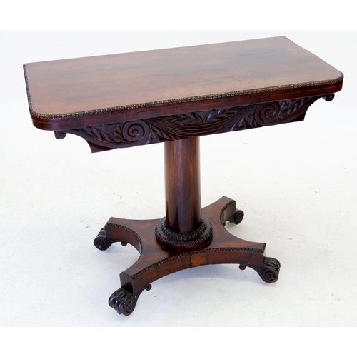 1242 - An early 19th century rosewood fold top card table with tapered colum and platform base