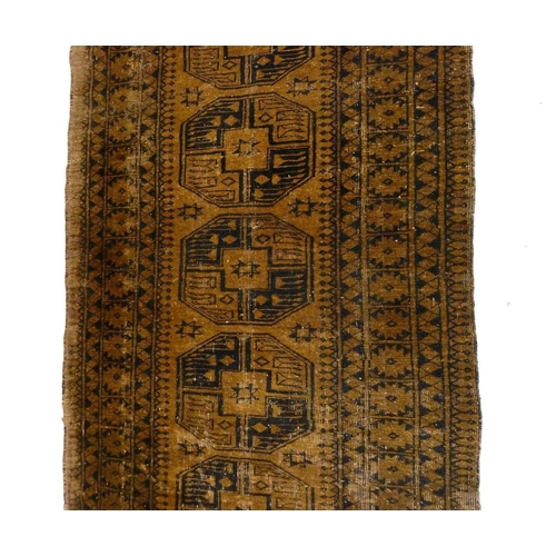 1244 - An antique Turkoman rug with large guls on a brown ground, 198 x 112 cm