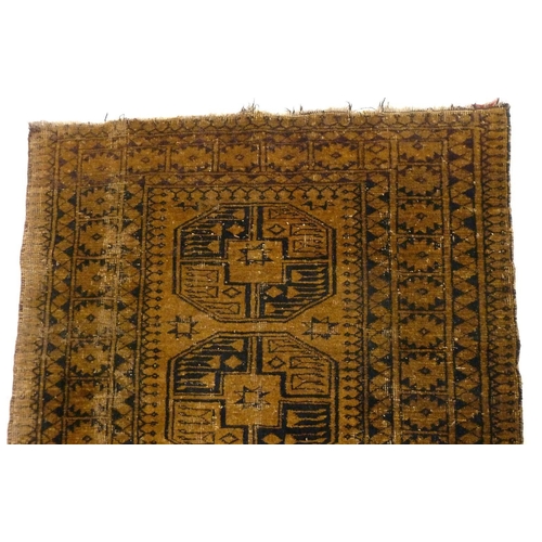 1244 - An antique Turkoman rug with large guls on a brown ground, 198 x 112 cm