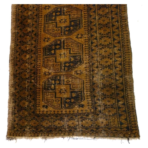 1244 - An antique Turkoman rug with large guls on a brown ground, 198 x 112 cm