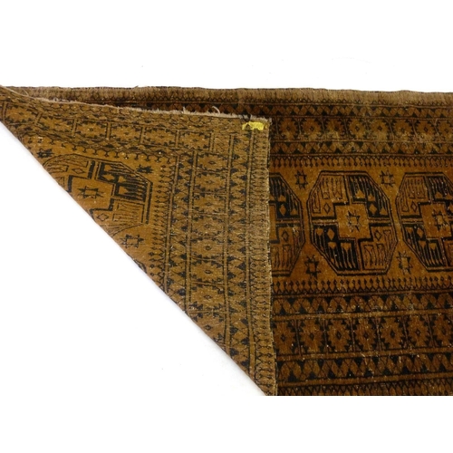 1244 - An antique Turkoman rug with large guls on a brown ground, 198 x 112 cm