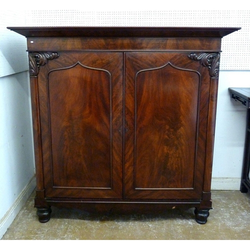 1253 - A Victorian mahogany two door linen cabinet with carved foliage decoration and arch panelled door, 1... 